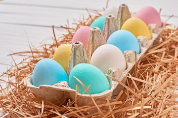 Colorful easter eggs in a paper tray close up
