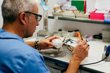 Caucasian man working on a dental prosthesis