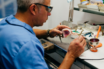 Caucasian man working on a dental prosthesis