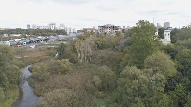 From a height overlooking the motorway and the church. Aerial video shooting in the city of Balashikha, Moscow region.
