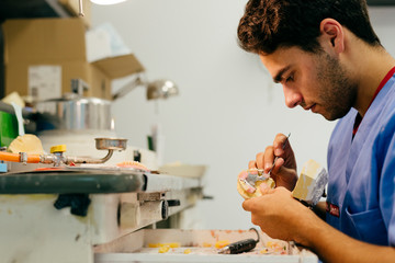 Caucasian man working on a dental prosthesis
