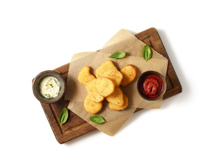 Fried chicken nuggets with white sauce and ketchup on a white background. Top view.