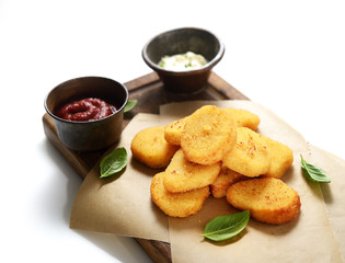 Fried chicken nuggets with white sauce and ketchup on a white background. 