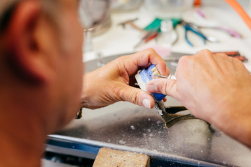 Caucasian man working on a dental prosthesis