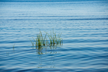 blue sky white clouds over calm body of water