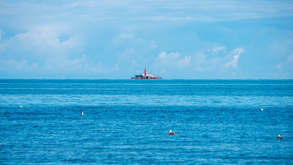 blue sky white clouds over calm body of water