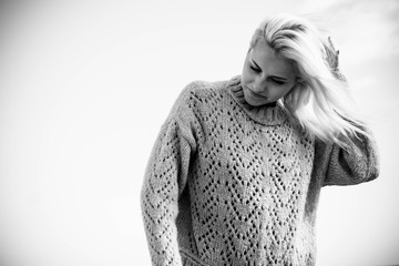 Black and white beautifuol portrait with cute attractive blonde girl looking down and pose with...