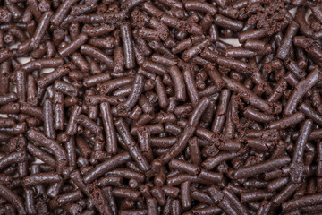 Sour cherry torte, cake cocoa sponge layers with cherry, cream filling and chocolate like art texture, background.