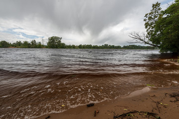 lakeside beach details with sand, rocks and blur background