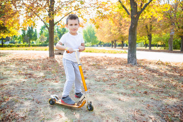 Playful boy on a scooter