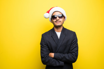 Christmas Concept. Handsome indian man wear santa hat on white isolated background.