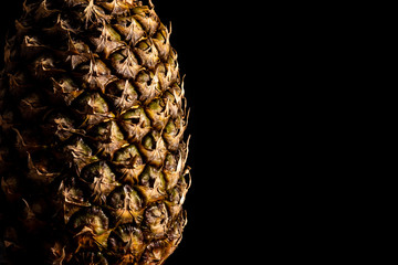 Fresh pineapple close up on black background