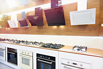 Modern gas stoves and hoods on display in store