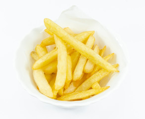 French Fries in a white dish on green grass on background, Close up..