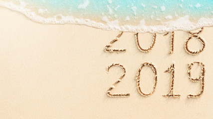 New Year concept - 2018 and 2019 written on the beach