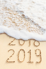 New Year concept. 2018 change to 2019, tropical beach background.