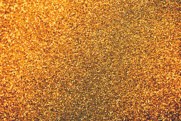 Golden glitter textured background for christmas and new year celebration party.