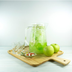 Cocktail Apple Italian soda in a glass jug on a on white background..