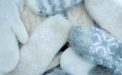 Knitted winter mittens grey and beige, soft texture, warm and cozy winter mood photography