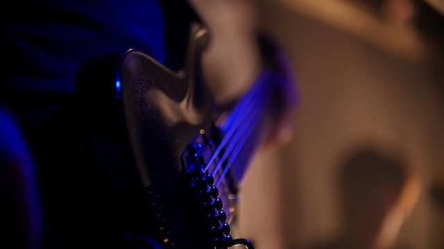 Drummer and guitarist play their parts in slow-mo on a rock band performance