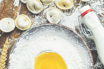 Ingredients and tools for baking and raw homemade italian ravioli, dumplings