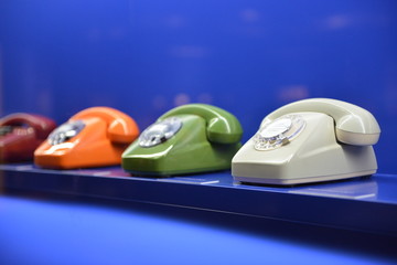 Old-fashioned retro 1960`s phones on blue background