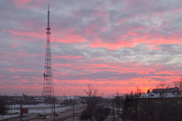 Omsk, Russia - December 07, 2018: Crimson dawn on the background of the TV tower of the Omsk television center in the early morning