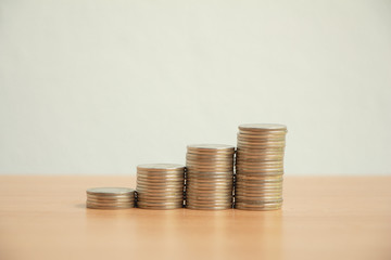 Stack of coins on wood table .saving money or growing business concept.