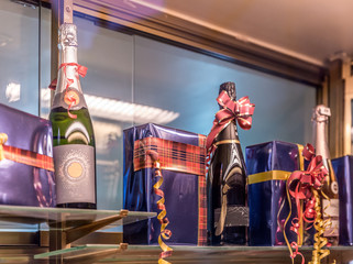 Champagne bottles next to boxes wrapped in wrapping paper