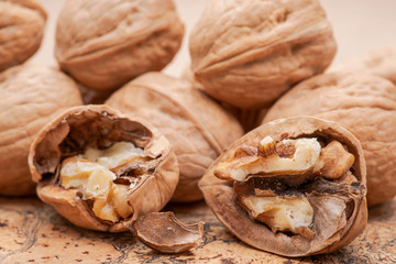 Brown premium raw organic walnuts on natural cork background.