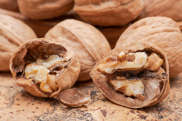 Brown premium raw organic walnuts on natural cork background.