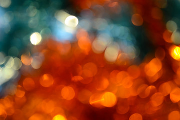 Bokeh. Holiday background. Christmas lights. Glitter. Defocused sparkles. New Year backdrop. Festive wallpaper. Blinks. Carnival. Bokeh retro style photo. Orange.