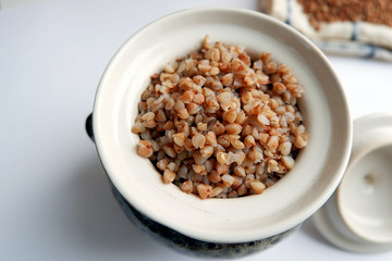 Soaked buckwheat in a clay pot, top view