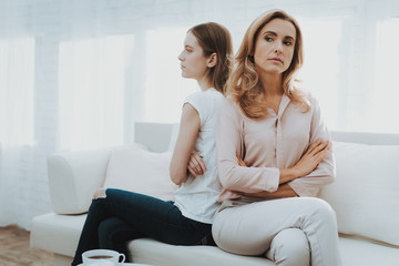 Obraz premium Woman Comforts Unhappy Teenage Daughter at Home.