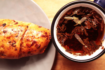 Pastries and a cup of tea on a wooden board