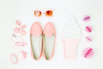 Flat lay of female fashion accessories, shoes, makeup products  on pastel color background. Beauty and fashion concept