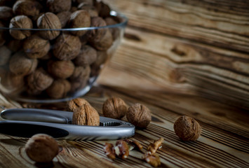 Walnuts are on the table next to a bowl of Nuts