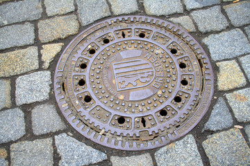 Dresden, Germany, metal sewer cover