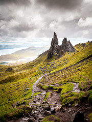 Old Man Of Storr Pinnacles, Scottland, Isle Of Skye - Picturesque mountain backdrop of the Scottish hiking paradise with spectacular rock formation surrounded by lush highland grass
