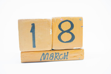march 18th. Day 18 of month, handmade wood calendar isolated on white background. Spring month, day of the year concept.