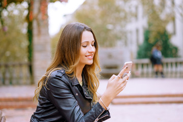 Portrait of happy women using smart phone outdoors