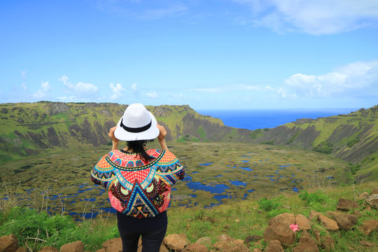 One Female Appreciating the Breathtaking View of Rano Kau Crater Lake from Orongo Ceremonial Village on Easter Island with Pacific Ocean in the Distance, Chile 