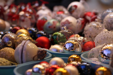 Assortment of balls toys for the Christmas tree in baskets in store.