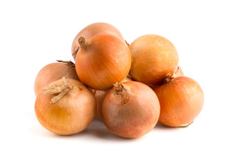 Several onions on a white background. Unpeeled fresh onions close up on a white background.