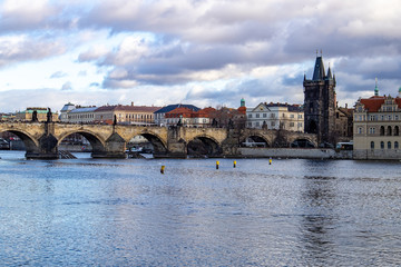 Obraz premium Prague, Czech Republic, Europe, panorama overlooking the historic buildings of Prague Castle, Charles Bridge and the Vltava River in front of interesting blue sky with clouds
