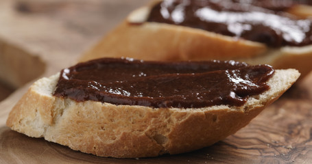 Closeup   of baguette slices with homemade hazelnut cream gianduja