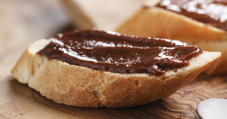 Closeup   of baguette slices with homemade hazelnut cream gianduja