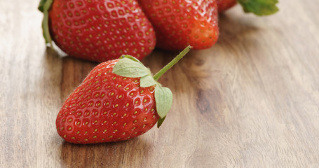 Closeup   of fresh strawberries on old wooden background
