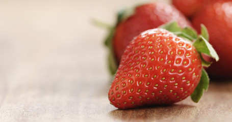 Closeup   of fresh strawberries on old wooden background