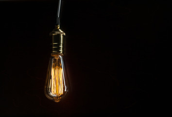 The light bulb illuminates on wooden background